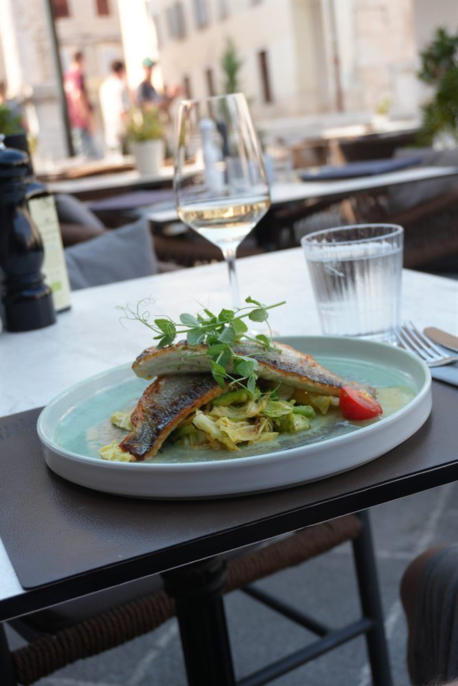 Sea bass and a glass of wine on the summer terrace